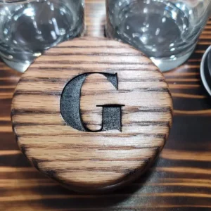 G written on a wooden box on a table