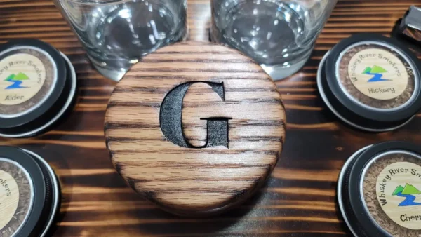 G written on a wooden box on a table