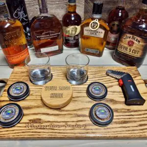 Bottles of whiskey kept on a table along with glasses