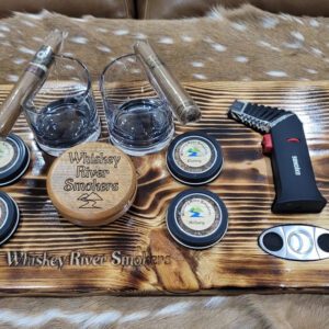 Pieces of glasses on a wooden rack with some cigars